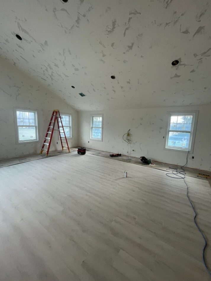 Finished interior addition with vaulted ceiling and new wood flooring