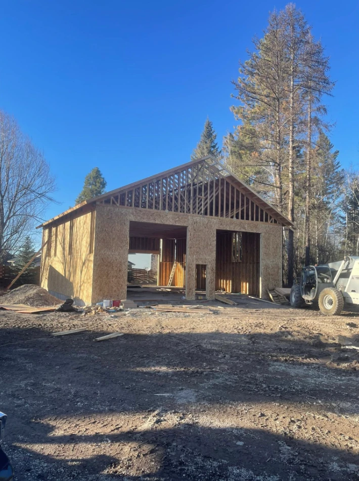 New shop building framed and sheathed on a clear Montana morning
