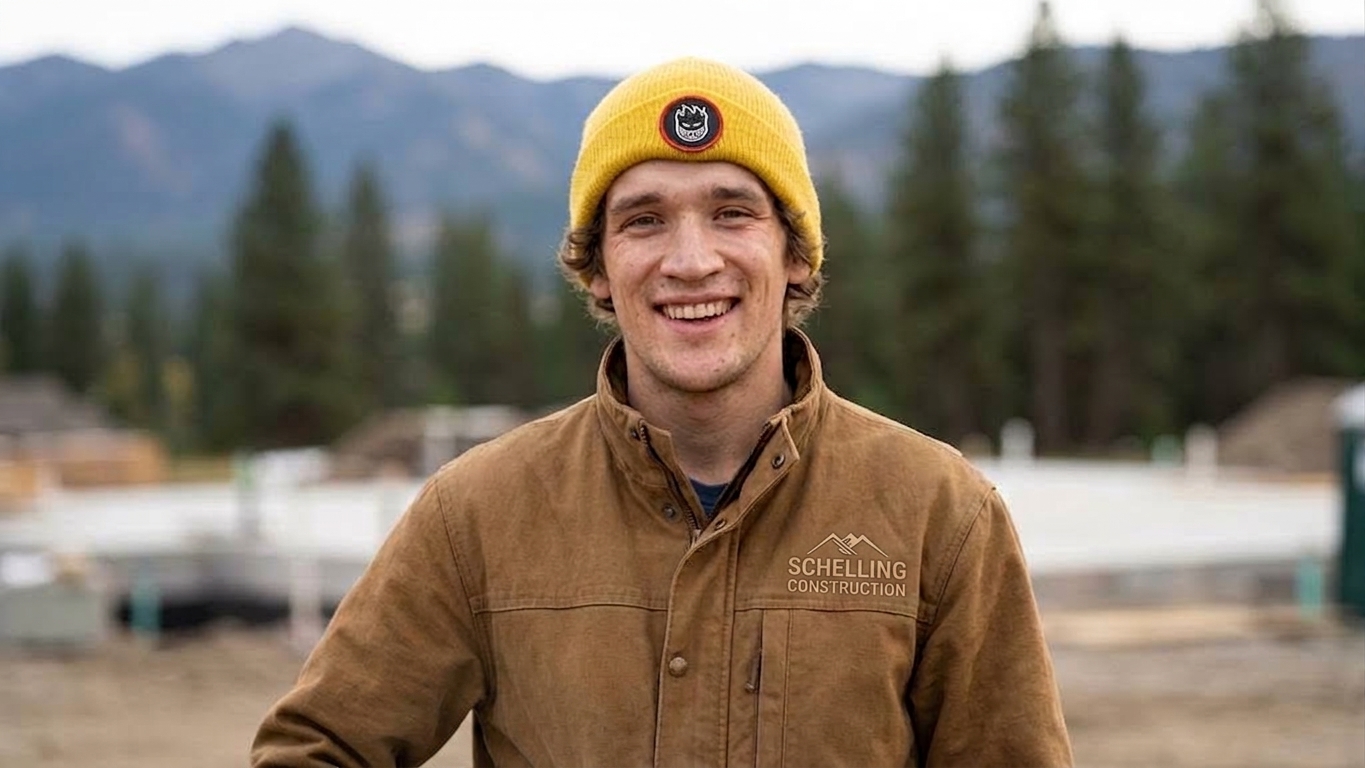 Mikey Schelling smiling on a job site in his Schelling Construction jacket